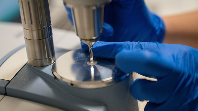 A CanTEST worker examining an unknown white powder.