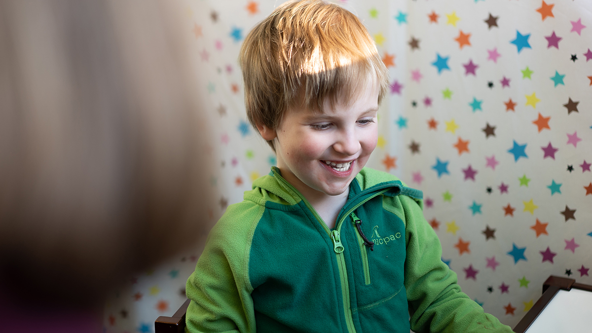 A boy smiling at the ANU Language Lab