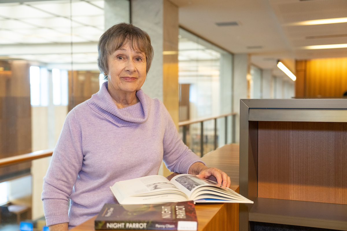 Dr Penny Olsen. Photo: Nic Vevers/ANU Woman with a book in library