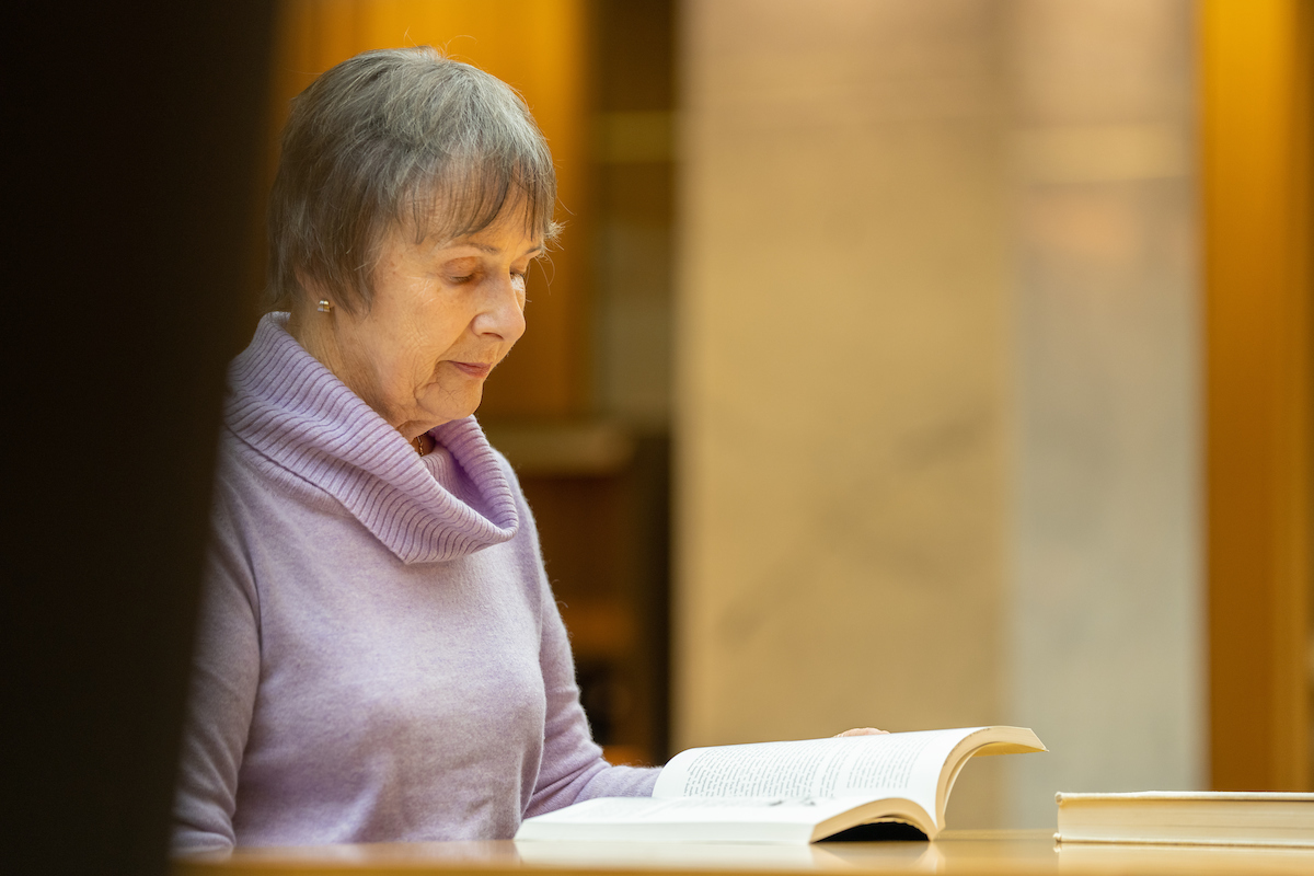 Dr Olsen at the National Library of Australia. Credit: Nic Vevers/ANU A woman reading a book at a desk
