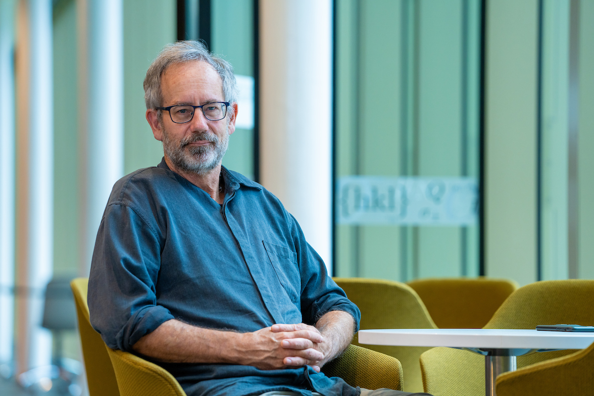 Professor John Close. Photo: Nic Vevers/ANU A man sitting in a green chair
