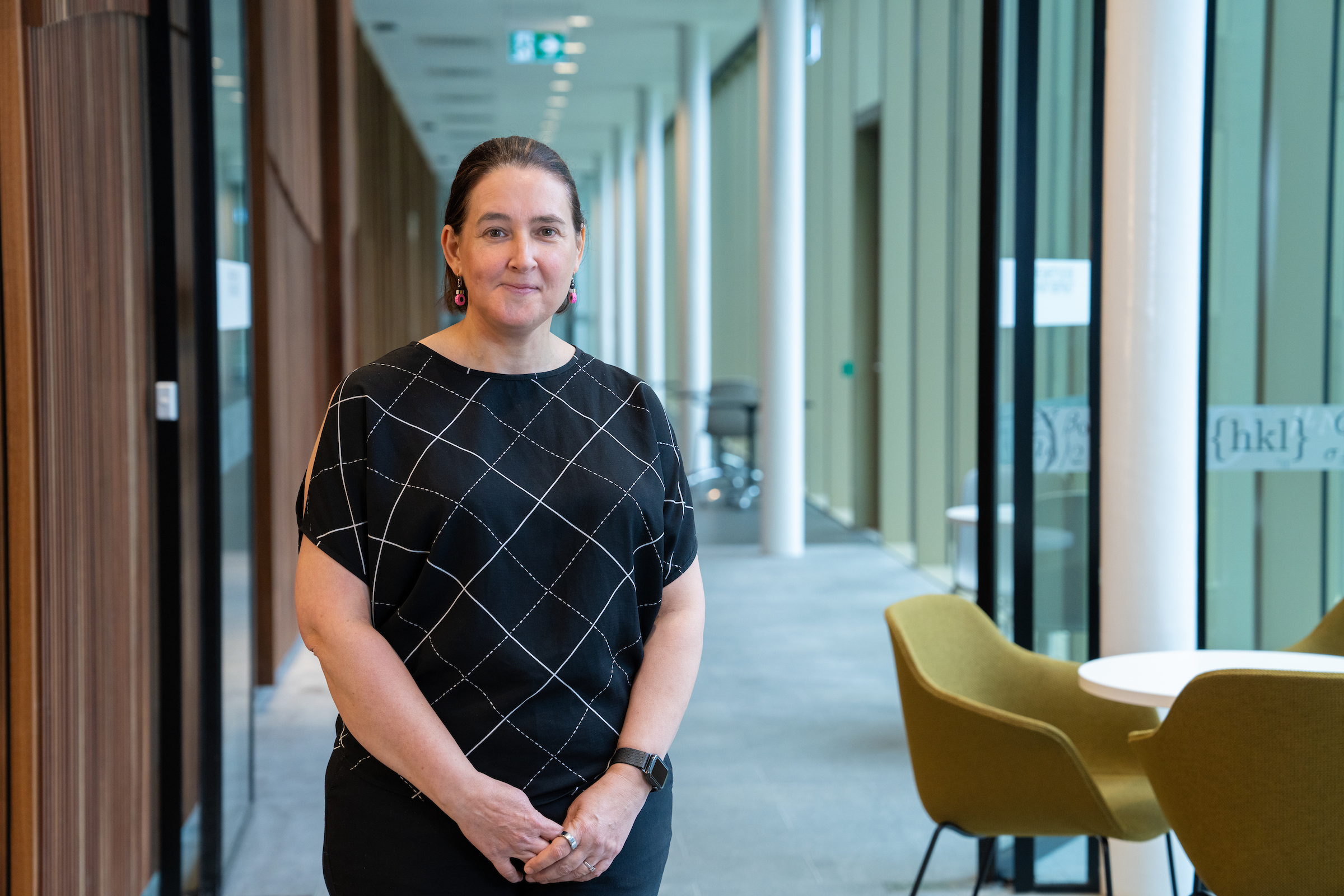 Professor Jodie Bradby. Photo: Nic Vevers/ANU A smiling woman standing in an office building