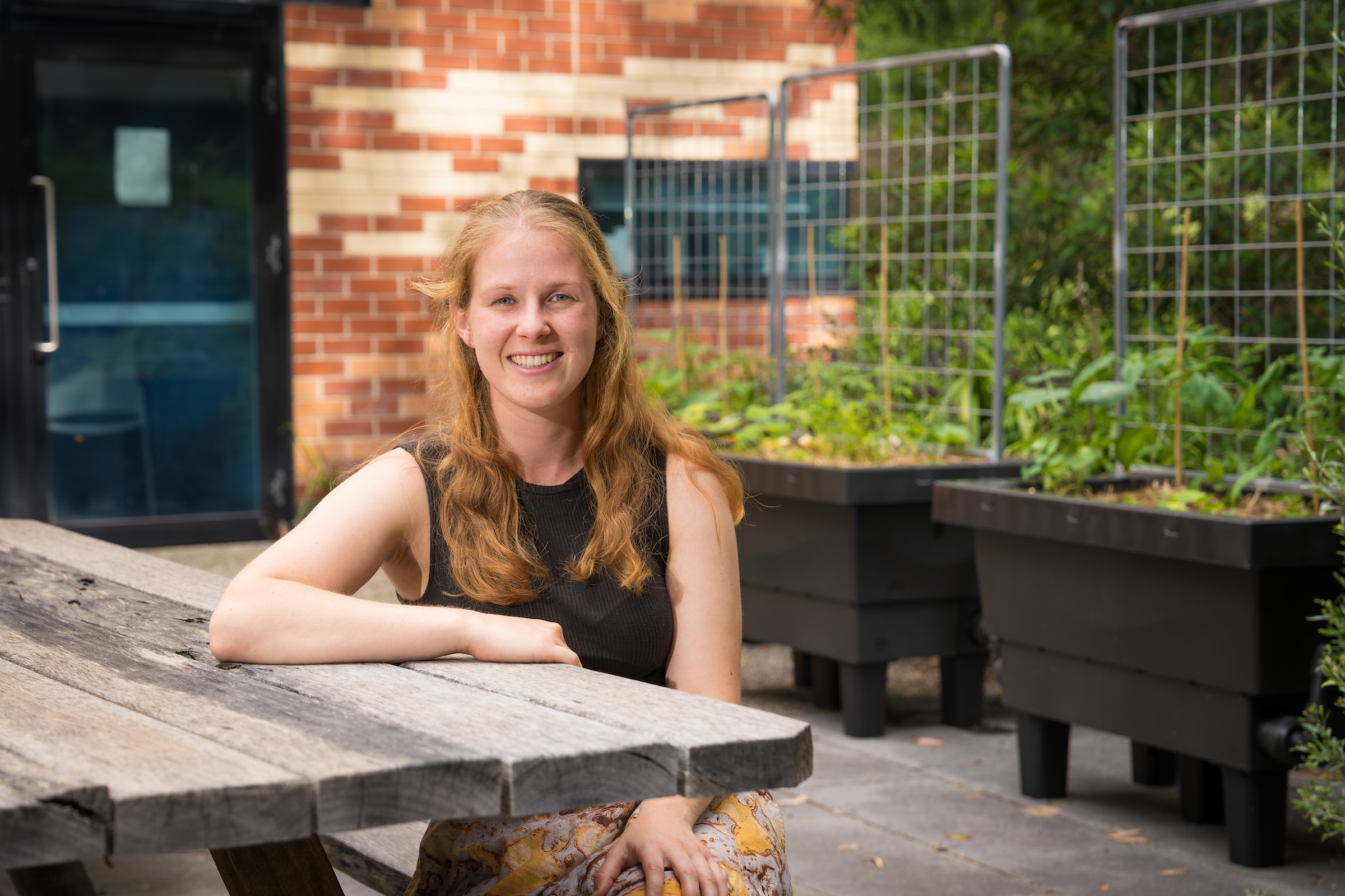 Isobel Bender. Photo: Nic Vevers/ANU A smiling woman sitting at an outdoor table