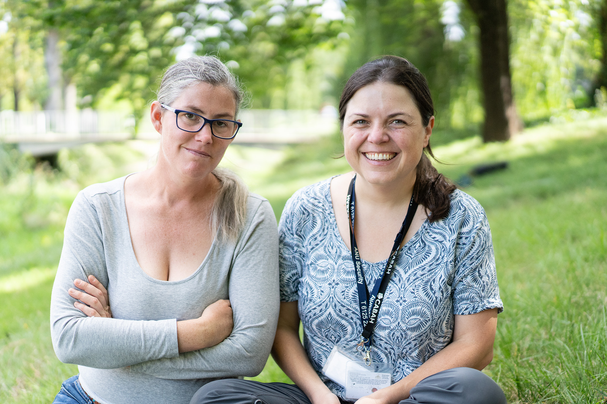 Dr Julia Jasonsmith and Associate Professor Larissa Schneider. Photo: Elsie Percival/ANU Two women sitting by a creek