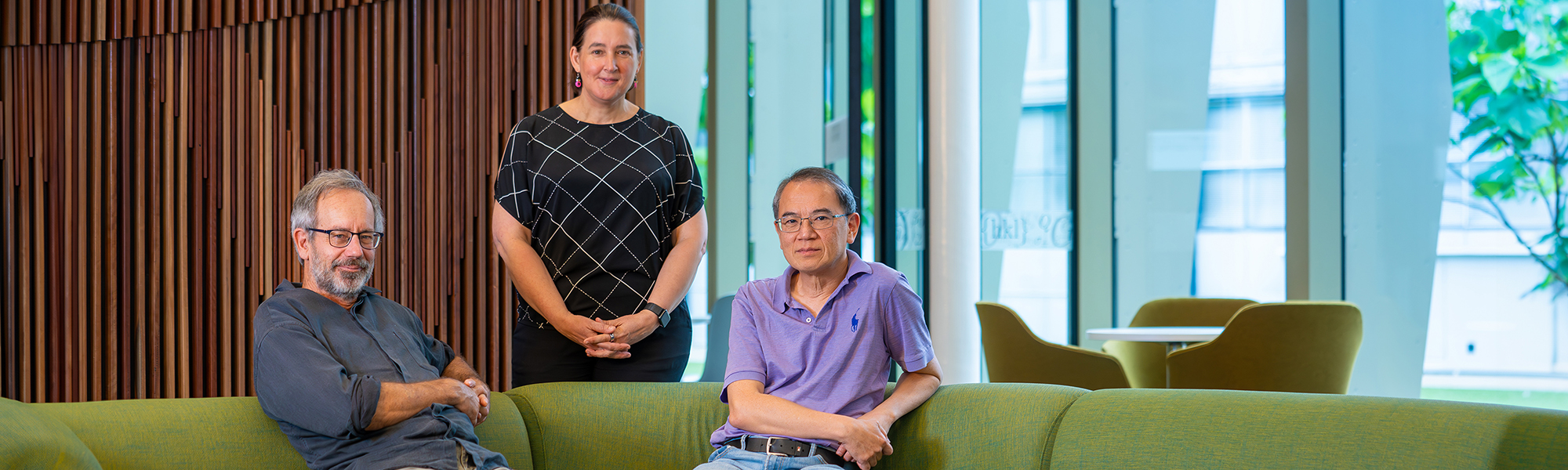 Professors John Close, Jodie Bradby and Hoe Tan. Photo: Nic Vevers/ANU Two men seated on a green sofa and a woman standing