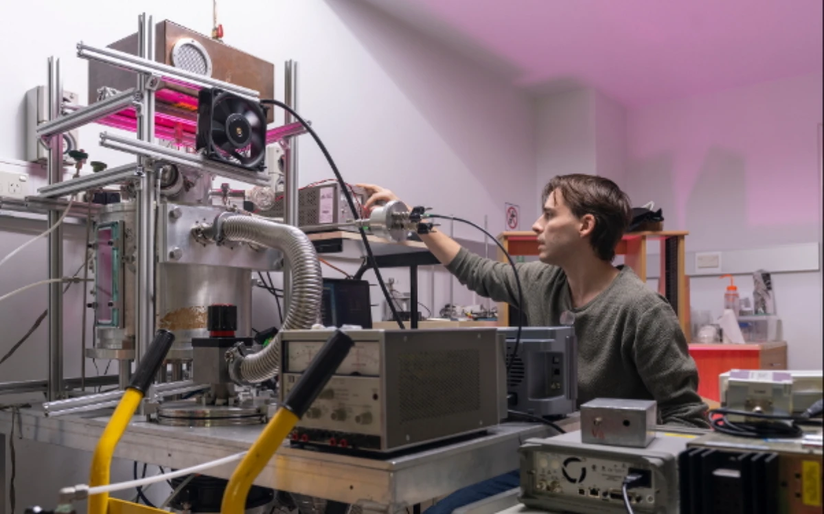 ANU PhD researcher Josef Richmond in the SP3 Laboratory at ANU with the prototype low-wavelength radiation source that will be used to degrade PFAS in water. Image: Jamie Kidston/ANU Scientist in a physics lab