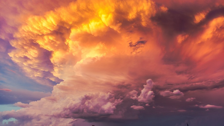 Dramatic sky with vibrant orange and purple clouds at sunset.