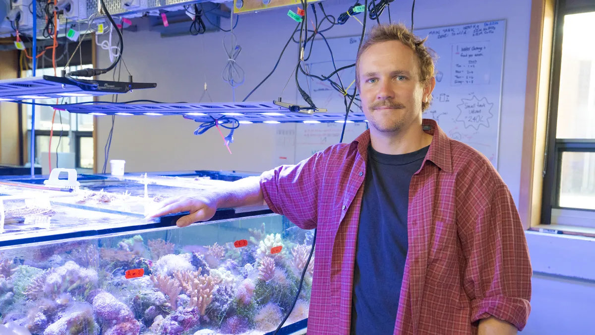 Man in front of aquarium