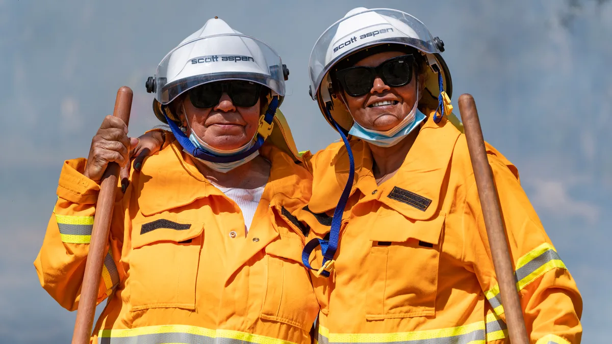 Two firefighters smiling