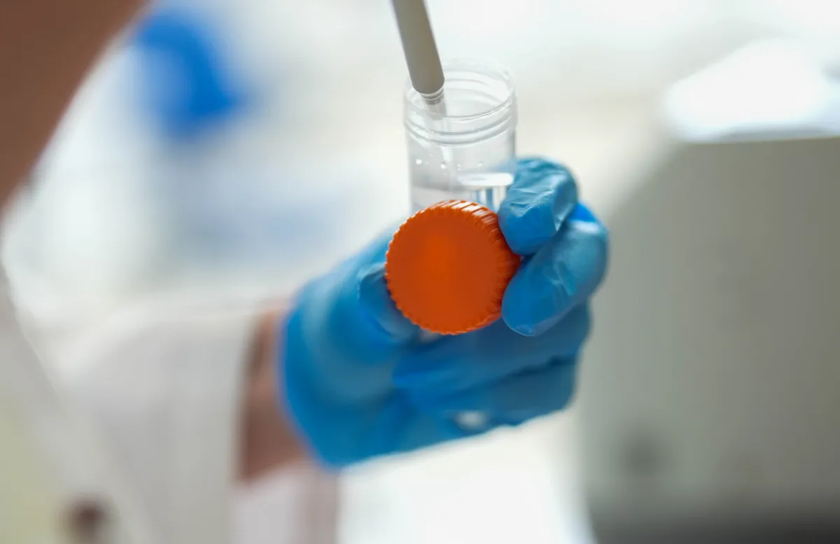 Vial in a gloved hand