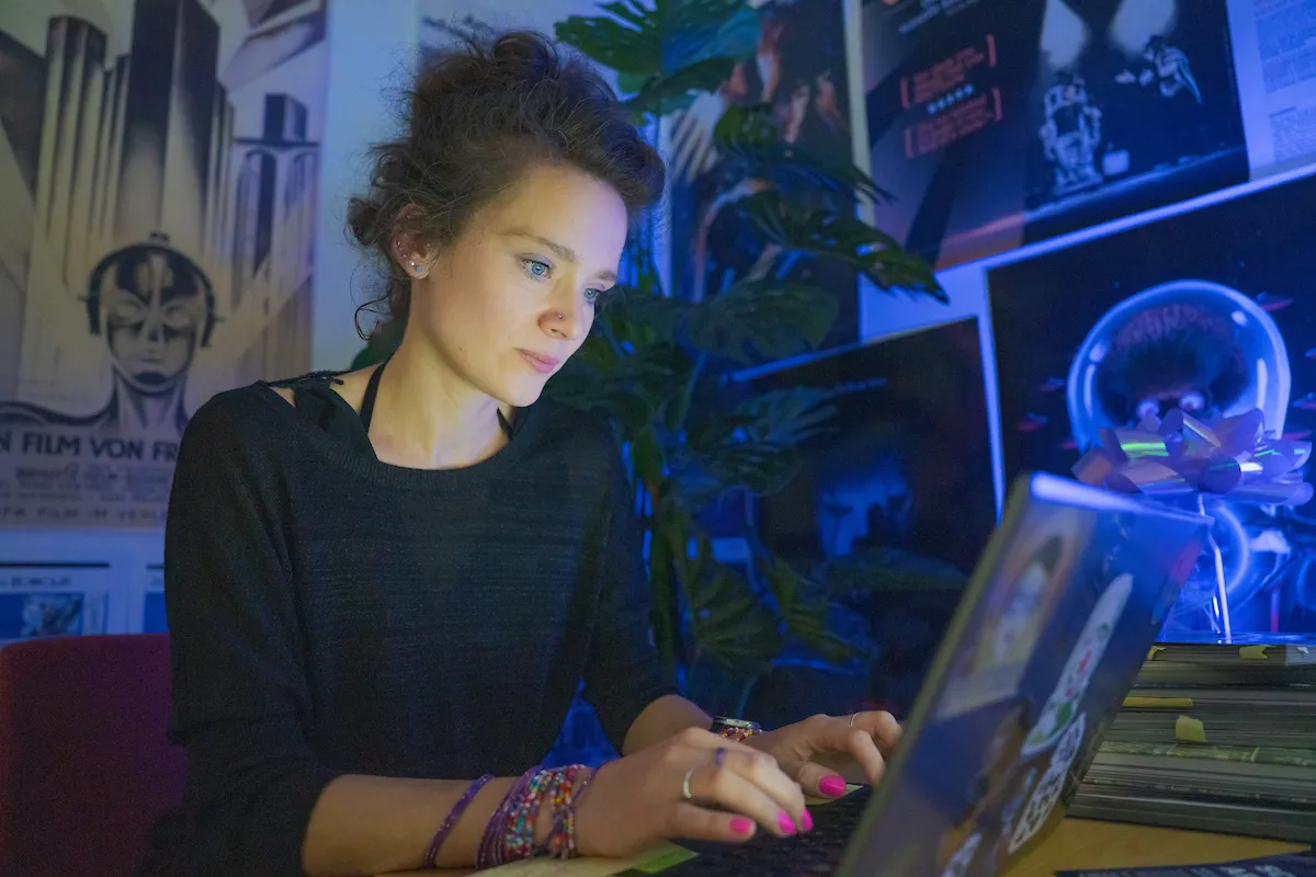 Woman at a desk with robot posters in background