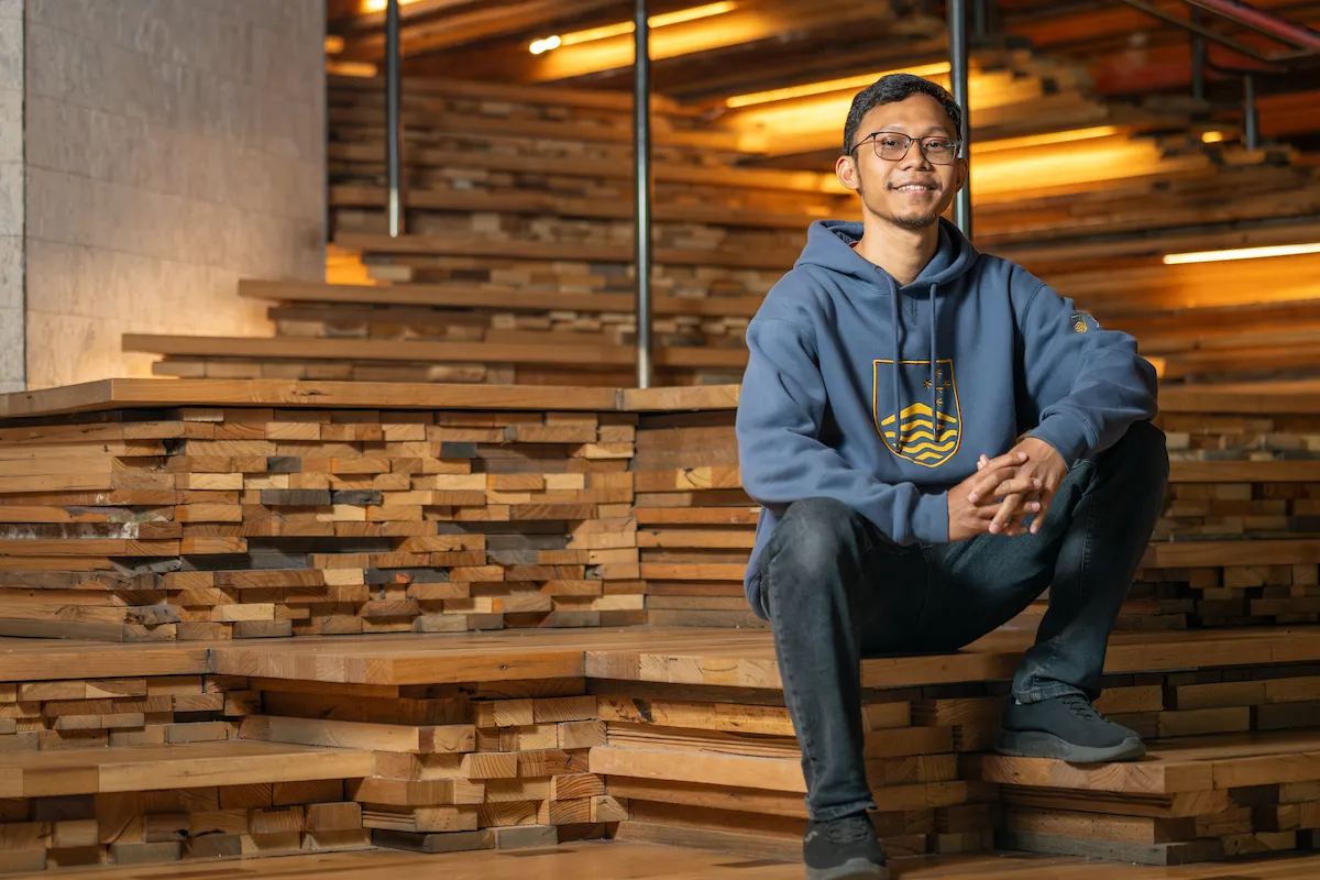 A man sitting on wooden steps