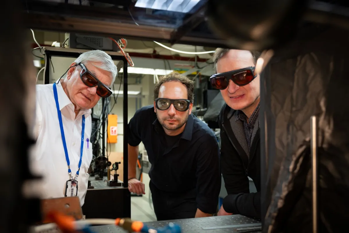 Professor Andrei Rode, Dr Ludovic Rapp and Professor Stephen Madden. Photo: Dave Fanner/ANU Three men in a lab wearing safety glasses