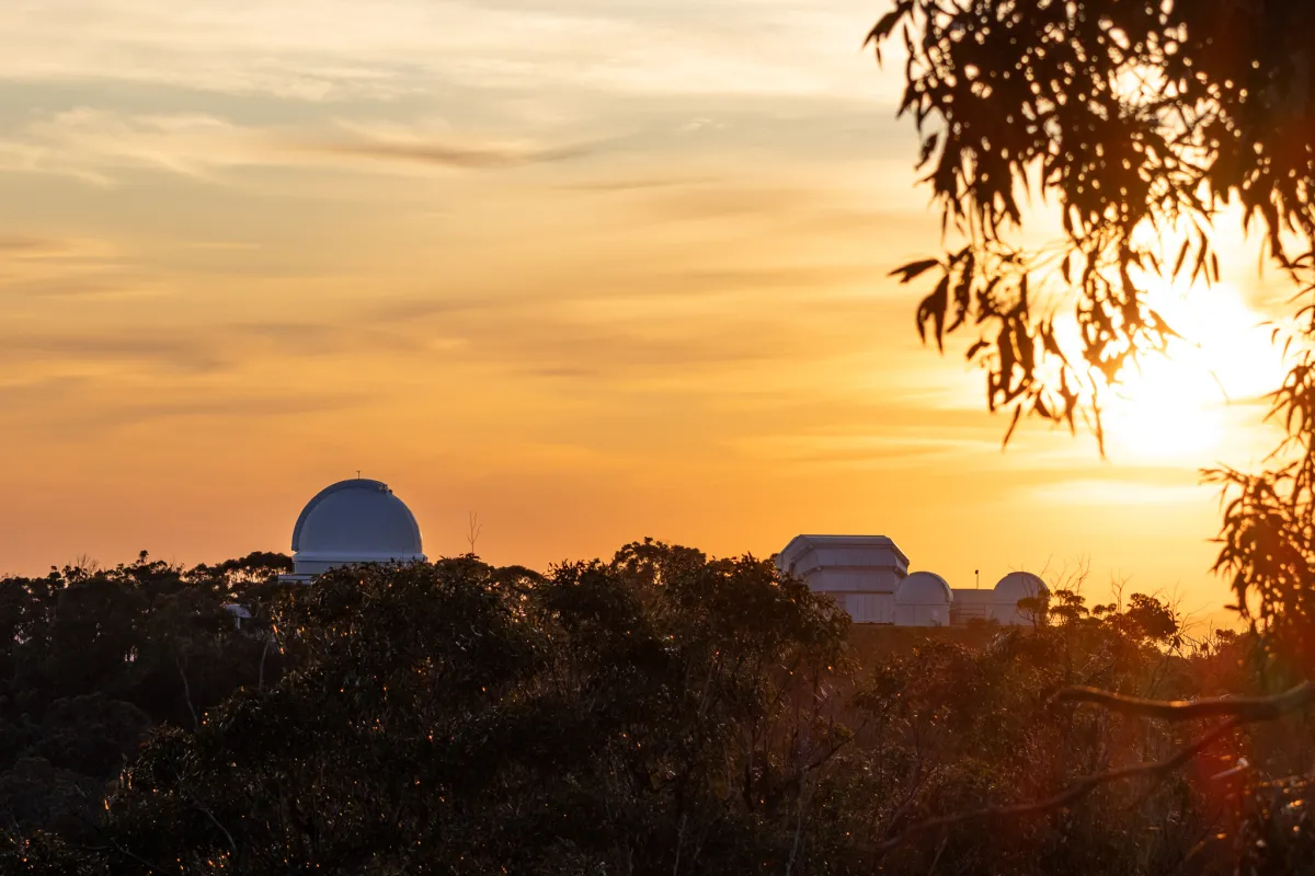 The sun rises over the observatory and the Warrumbungle National Park. Photo: Olivia Congdon/ANU Sunrise at Siding Spring