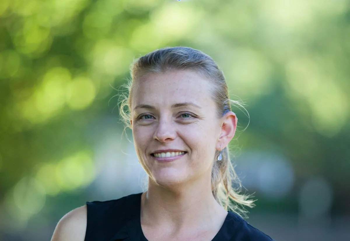 A headshot of a smiling woman