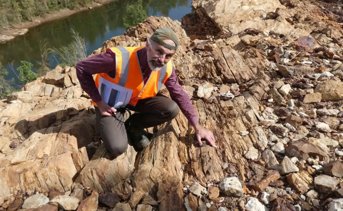 Professor Jochen Brocks is inspecting layers of rock above a river