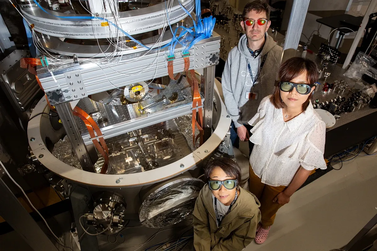Physicists in lab wearing PPE