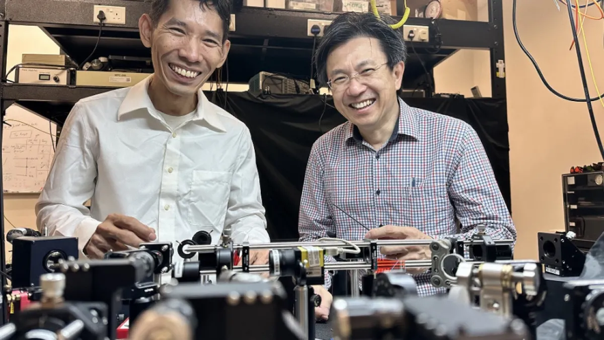 Two mean in front of lab equipment