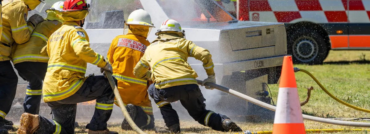 Emergency service workers fighting a car fire