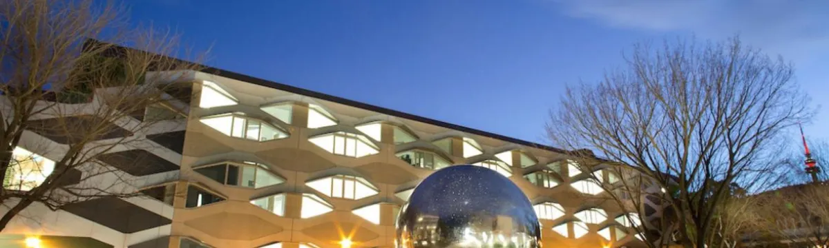 Science precinct showing biology building and sculpture of a large metallic ball