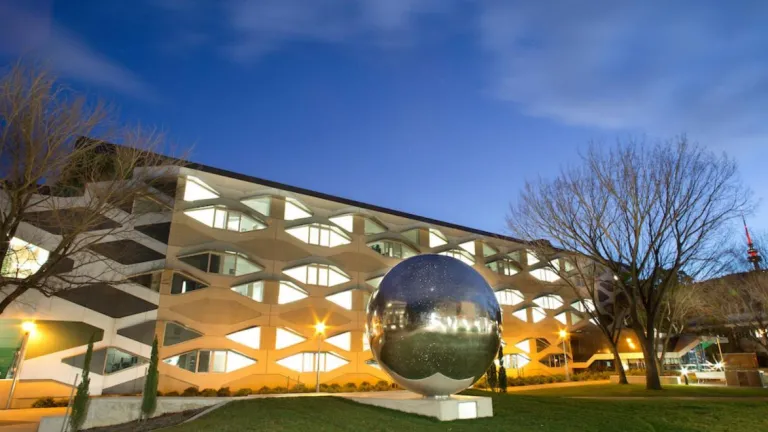 Science precinct showing biology building and sculpture of a large metallic ball