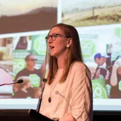 A woman speaking at a lectern
