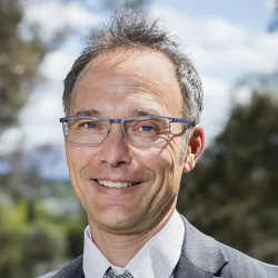A man in glasses smiling