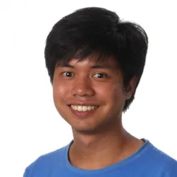 A smiling man in a blue t shirt