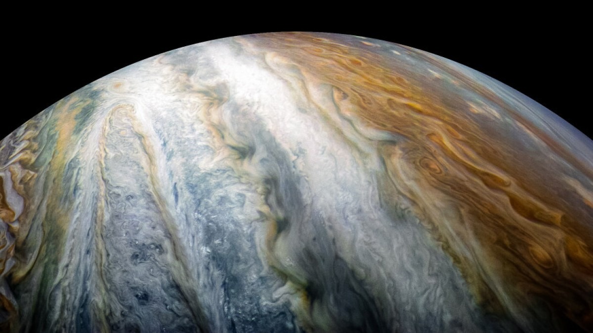 Jupiter showing colourful cloud swirls. 