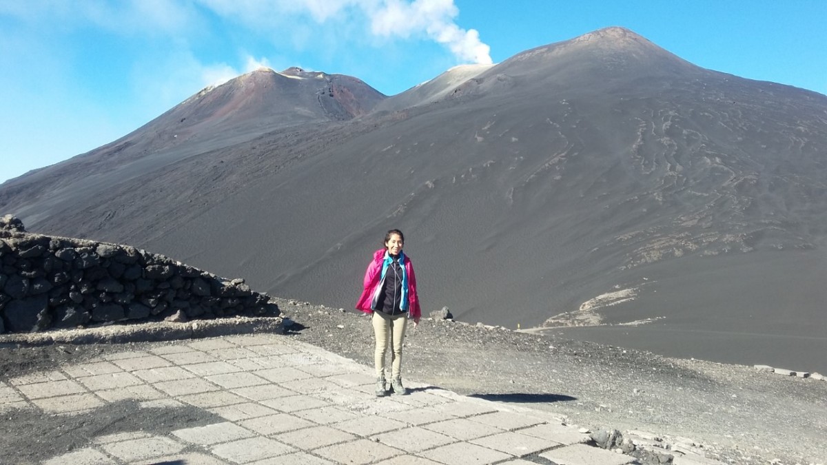 Dr Casas Ramos is standing below the peak of a black smouldering volcano.