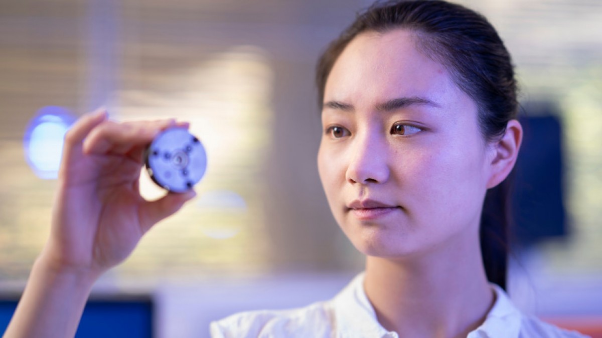 Xingshuo Huang holds a diamond anvil  used to make diamonds in the lab