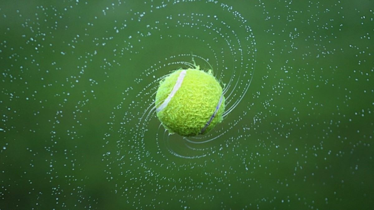 Tennis ball, spinning in air.
