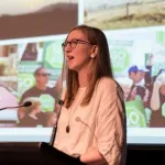 A woman speaking at a lectern