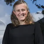 A smiling woman in a black shirt