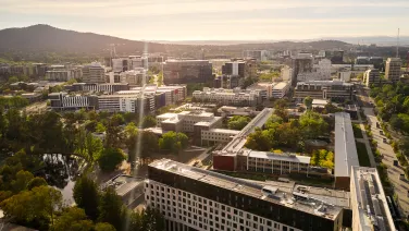 Aerial view of ANU campus, showing buildings, ovals and Black Mountain.