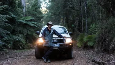 Man in forest with vehicle