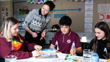 Young people and teacher doing science activities in a classroom