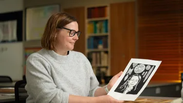 Woman holds portrait