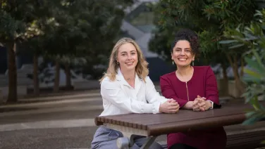 Dr Lucy Gloag and Dr Sima Mousavi sitting outside.