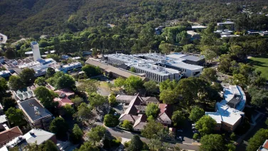 Aerial view of ANU campus, showing buildings, ovals and Black Mountain.