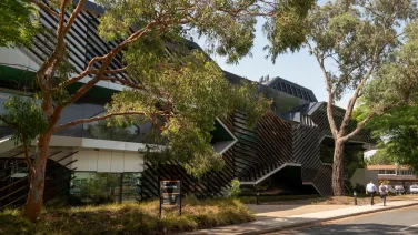 Building with trees in foreground.
