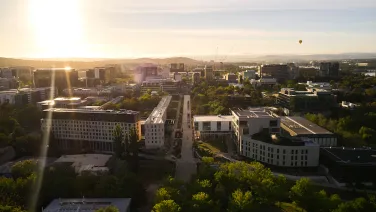 Aerial view of ANU campus, showing buildings and ovals.