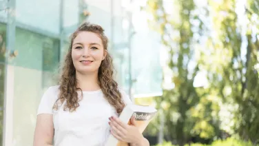 Student holding psychology book