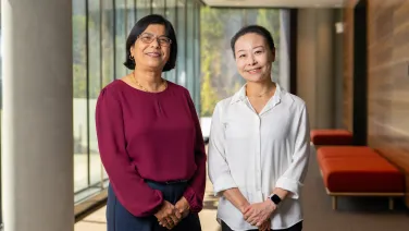 ANU researchers Professor Mahananda Dasgupta (left) and Professor Lan Fu (right) are pictured in a foyer