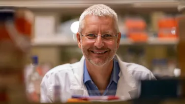 headshot of a man in a lab