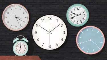 Five clocks on dark wall.