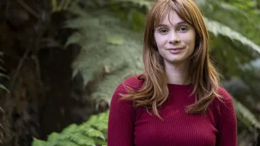 Molly Folkard amongst ferns at the Botanic Gardens.