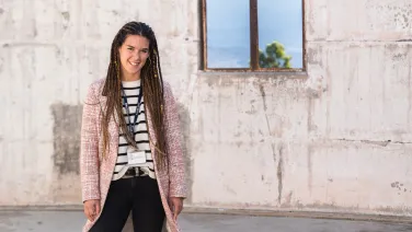 Dr Noelia Martinez Rey is standing inside the ruins of a telescope destroyed by bushfire.