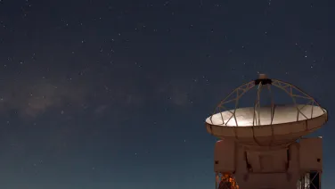 Telescope at night with stars in background